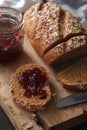 Dark multigrain bread whole grain and jam fresh baked on rustic