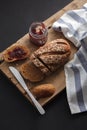 Dark multigrain bread whole grain and jam fresh baked on rustic Royalty Free Stock Photo