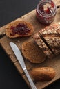 Dark multigrain bread whole grain and jam fresh baked on rustic Royalty Free Stock Photo