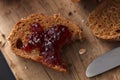 Dark multigrain bread whole grain and jam fresh baked on rustic Royalty Free Stock Photo