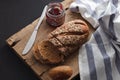 Dark multigrain bread whole grain and jam fresh baked on rustic Royalty Free Stock Photo