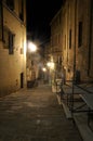 Dark narrow alley with old buildings and street lamps in Siena,Tuscany