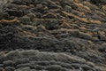 Dark natural black volcanic rock in layers as abstract texture background Royalty Free Stock Photo