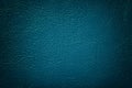 Dark navy blue leather texture background, closeup. Turquoise cracked backdrop from wrinkle skin