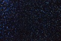 Dark navy blue sparkling background from small sequins, closeup. Brilliant shiny backdrop from textile. Shimmer paper Royalty Free Stock Photo