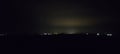 dark night behind the city with a few lights in the distance, sky without stars, dark night, panorama Royalty Free Stock Photo