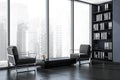 Dark office room interior with panoramic window, two comfortable armchairs Royalty Free Stock Photo