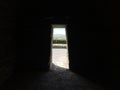 Dark old room and illuminated stones door Royalty Free Stock Photo