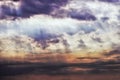 Dark ominous clouds. Dramatic sky with sunbeams