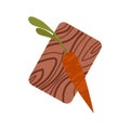 Dark Orange Carrot with Tops on Chopping Board