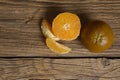 Dark orange isolated on wooden background. Brown oranges Royalty Free Stock Photo