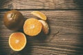 Dark orange isolated on wooden background. Brown oranges Royalty Free Stock Photo