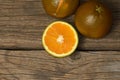 Dark orange isolated on wooden background. Brown oranges Royalty Free Stock Photo