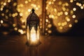 Dark ornamental Moroccan lantern burning at night. Muslim holiday Ramadan Kareem festive blurred background. Glittering