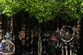 Dark outdoor view of a lot of hippie and colorful dream catchers with feather decorations and intricate patterns hanging Royalty Free Stock Photo