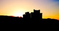 Outlines of residential tall houses with sunset sky.