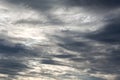 Dark overcast sky with rainy clouds and sun shining through them Royalty Free Stock Photo