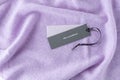 Dark paper tag with word 100% cashmere on light violet luxury pure cashmere background Royalty Free Stock Photo