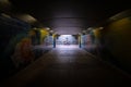 Dark pedestrian tunnel with one motion blurred cyclist, Abu Dhabi