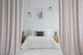 Pink curtains in bright bedroom