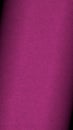 Dark pink colored paper texture. Textured mobile phone wallpaper with vignetting. Tinted vertical background. Small patterned Royalty Free Stock Photo