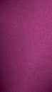 Dark pink colored paper texture. Tinted vertical background with vignetting. Textured mobile phone wallpaper. Large patterned Royalty Free Stock Photo