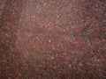 Dark pink granite background used for kitchen worktop, table, window sill, fence.Red violet igneous rock stone texture Royalty Free Stock Photo