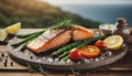 Dark plate with Grilled salmon steak with asparagus, tomatoes and lemons, lunch with view on sea Royalty Free Stock Photo