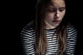 Dark portrait of a depressed teen girl