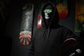 A dark portrait of a masked vandal rebel, a skateboard in his hand, green glasses, to protest the death of George Floyd,