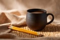 Dark Pottery Mug with Pencils on Woven Placemat Royalty Free Stock Photo