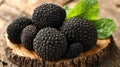 Dark, prized black truffles on a wooden slice Royalty Free Stock Photo