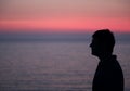 Dark profile of man with glasses and the background of a beautif