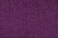 Dark purple background from woolen texture textile, closeup. Structure of the wicker fabric macro. Royalty Free Stock Photo