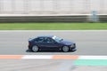 Dark purple BMW E36 racing car driving on a track