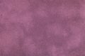 Dark purple matte background of suede fabric, closeup. Velvet texture of textile Royalty Free Stock Photo