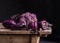 Dark purple peppers, cauliflower with leaves of basil Royalty Free Stock Photo