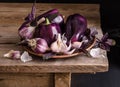 Dark purple peppers with leaves of basil and garlic Royalty Free Stock Photo