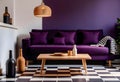 Dark purple sofa with a blanket beside a small table Royalty Free Stock Photo