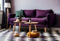 Dark purple sofa with a blanket beside a small table Royalty Free Stock Photo
