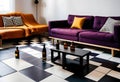 Dark purple sofa with a blanket beside a small table Royalty Free Stock Photo