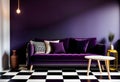 Dark purple sofa with a blanket beside a small table Royalty Free Stock Photo