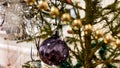 Dark purple vintage glass bauble hanging on green fir tree at home. Retro style ornaments on Christmas tree. Xmas decor Royalty Free Stock Photo