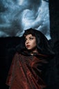 Dark queen of the ghost in a dark castle collapsed, visible destruction of the castle wall and dark storm clouds Royalty Free Stock Photo