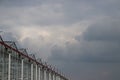 Dark rain clouds above the glass greenhouses for roses in the town of Moerkapelle, The Netherlands