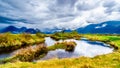 Dark rain clouds on a cold spring day at over the Pitt River and the lagoons of Pitt-Addington Marsh in Pitt Polder at Maple Ridge Royalty Free Stock Photo