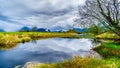 Dark rain clouds on a cold spring day at over the Pitt River and the lagoons of Pitt-Addington Marsh in Pitt Polder at Maple Ridge Royalty Free Stock Photo