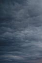 Dark rain clouds in the evening sky. Dramatic sky with an coming cloudy cyclone of bad weather