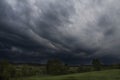 Dark rain clouds over field. Royalty Free Stock Photo