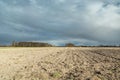 Dark rain clouds over a plowed field, spring rural view Royalty Free Stock Photo